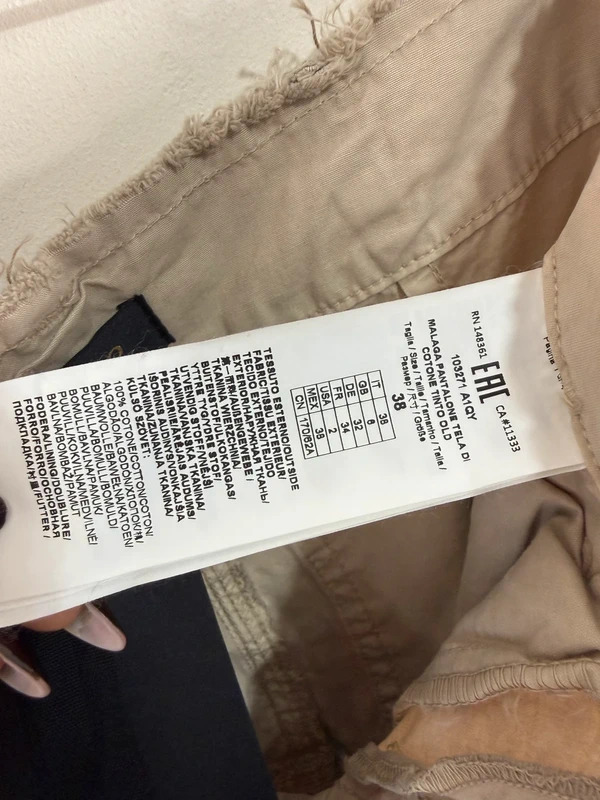 Pinko care label with a printed size grid reading IT 38, GB 6, DE 32, FR 34, USA 2