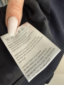 Acne Studios care label: do not dry clean, hand wash, do not tumble dry, do not bleach, dry flat, wash inside out