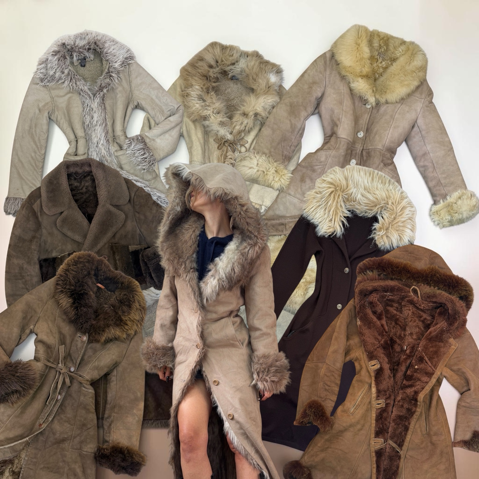Ten long suede and shearling coats with shaggy fur collars and cuffs laid out together, one worn with the hood up